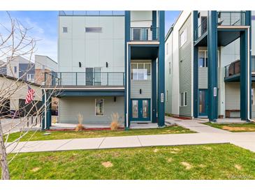 Modern townhome featuring a sleek blue and gray facade, private balconies, and well-maintained landscaping at 3220 W 20Th Ave # 1, Denver, CO 80211