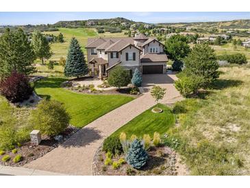 Stunning home featuring a grand circular driveway and beautifully landscaped front yard in a desirable location at 5192 Sedona Dr, Parker, CO 80134