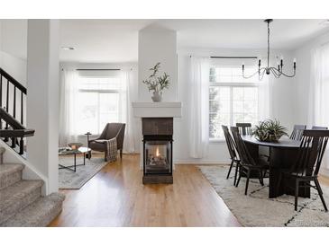 Bright living room featuring a modern fireplace, wood floors, and neutral decor, creating a cozy and inviting space at 4500 E Louisiana Ave, Denver, CO 80246
