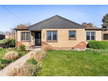 Charming brick home with a well-maintained lawn and tidy landscaping in a suburban neighborhood at 2801 N Garfield St, Denver, CO 80205
