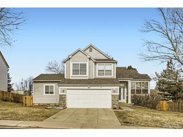 Charming two-story home with a two-car garage, stone accents, and a well-manicured lawn at 19827 E Prentice Ave, Centennial, CO 80015