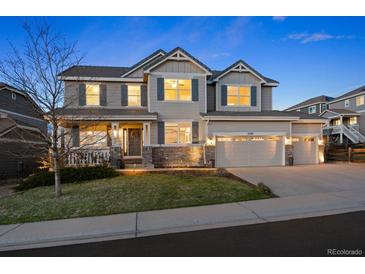 Charming two-story home featuring a manicured lawn, attached two-car garage, and well-maintained landscaping at 2090 Bellavista St, Castle Rock, CO 80109