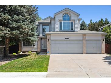 Charming two-story home boasts a three-car garage and well-maintained front yard at 13362 Marion St, Thornton, CO 80241