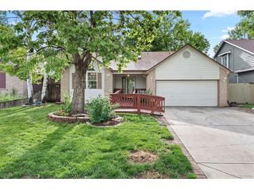 Charming single-Gathering home with well-manicured lawn, mature trees, and a cozy front porch at 204 Maple St, Frederick, CO 80530