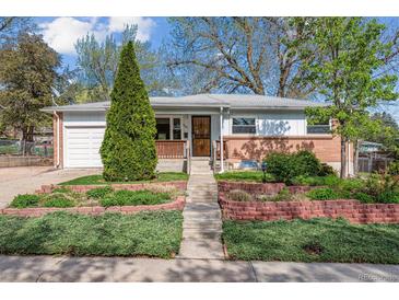 Charming single-story home featuring a brick facade, well-kept lawn and mature trees at 6882 Moore St, Arvada, CO 80004