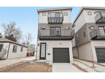 Modern three-story home with two balconies and an attached one-car garage at 2162 S Ash St, Denver, CO 80222