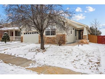 Charming single-Gathering home with a well-maintained front yard and an attached two-car garage at 16278 E 105Th Way, Commerce City, CO 80022