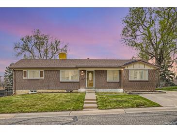 Charming brick home with well-manicured lawn and a lovely glass-accented front door at 3150 W Stanford Ave, Englewood, CO 80110