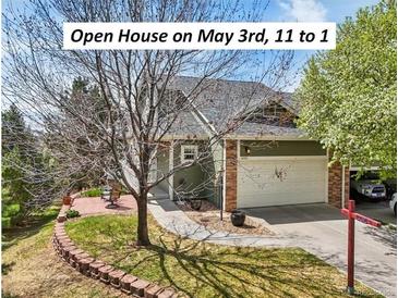 Charming home with a two-car garage, manicured lawn, and inviting brick-paved patio at 6701 W Yale Ave, Lakewood, CO 80227