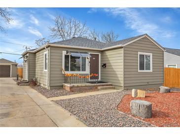 Updated ranch home with a landscaped yard and spacious driveway at 5065 Eliot St, Denver, CO 80221