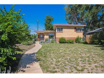 Charming brick home with a well-manicured lawn and inviting walkway, perfect for suburban living at 1497 S Garfield St, Denver, CO 80210