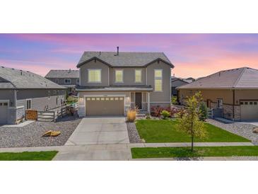 Beautiful two-story home featuring a well-manicured lawn, a two car garage, and lovely landscaping at 16268 Mount Silverheels Way, Broomfield, CO 80023