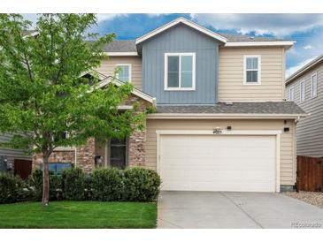 Inviting two-story home featuring a two-car garage, stone accents, and a well-manicured front lawn at 4025 Trail Stone Cir, Castle Rock, CO 80108