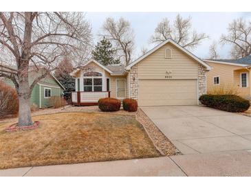 Charming single-story home featuring a two-car garage and a cozy front porch with decorative stone accents at 6522 S Hoyt Way, Littleton, CO 80123