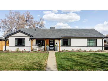 Charming single-story home features a well-manicured lawn and cozy covered porch seating area at 1248 Ursula St, Aurora, CO 80011