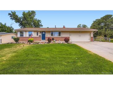 Charming ranch-style home with manicured lawn, brick accents, and a two-car garage at 4244 W Monmouth Ave, Littleton, CO 80123