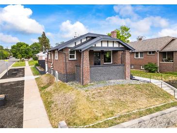 Charming brick bungalow with a covered front porch and a well-maintained front yard at 3458 N Clayton St, Denver, CO 80205