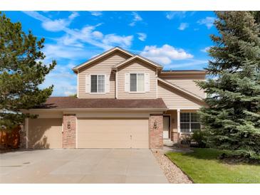Charming two-story home with a three-car garage, landscaped yard, and traditional architectural details at 737 Novick Ct, Castle Rock, CO 80109