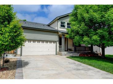 Charming home featuring a two-car garage, driveway, and mature landscaping enhancing its curb appeal at 7245 Prairie Cir, Longmont, CO 80504