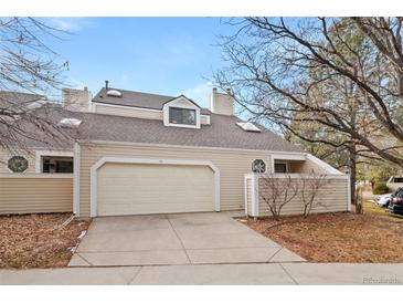 Inviting home with a two-car garage, neutral siding, and mature landscaping at 141 S Fraser Cir, Aurora, CO 80012