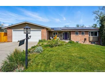 Charming single-Gathering home featuring a well-maintained front yard, brick accents, and solar panels at 11715 W 30Th Pl, Lakewood, CO 80215