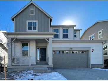 Charming two-story home with a two-car garage, stylish gray and white color scheme, and inviting front porch at 5546 Inland Ave, Firestone, CO 80504