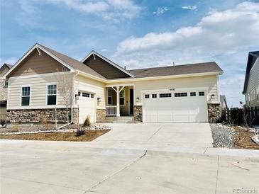 A charming one-story home boasting a two-car garage and a well-manicured lawn, blending comfort and curb appeal at 9032 Middle Fork St, Littleton, CO 80125