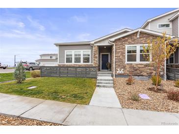 Modern two-story home with stone accents and landscaped front yard at 15501 E 112Th Ave # 6F, Commerce City, CO 80022