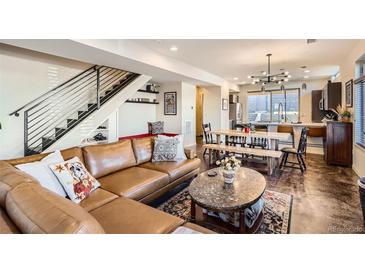 Open living room boasts a modern design, featuring a dining area and staircase to the left at 3361 Mariposa St, Denver, CO 80211