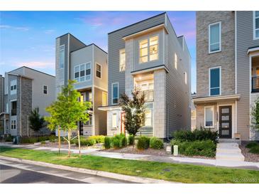 Contemporary home with clean lines, gray and white facade, professional landscaping, and inviting entrance at 12261 Farmview St, Thornton, CO 80241