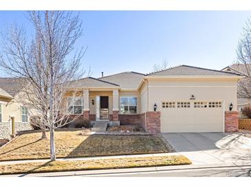 Charming single-story home featuring stucco siding, brick accents, and a well-manicured front yard at 4894 Bierstadt Loop, Broomfield, CO 80023