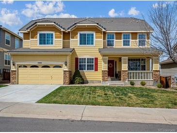 Two-story home with a large front yard, covered porch, and a two-car garage at 3309 Springbriar Dr, Castle Rock, CO 80109