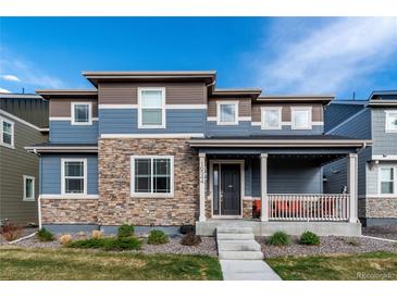 Charming two-story home with stone accents and a welcoming front porch at 16544 E 118Th Dr, Commerce City, CO 80022