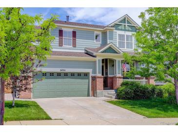 Charming two-story home with a two car garage, lush lawn and mature trees at 24351 E Alamo Dr, Aurora, CO 80016