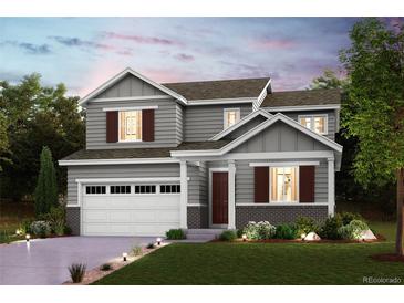 Charming two-story home features gray siding, brown shutters, and a well-maintained lawn at 14096 Bunny Hop Ln, Parker, CO 80134