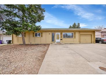 Charming single-story home with a front yard, driveway, and attached garage providing convenient parking at 2971 S Sheridan Blvd, Denver, CO 80227