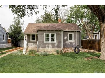 Charming gray home with a well-maintained lawn and a tire swing in the front yard at 2655 S Humboldt St, Denver, CO 80210