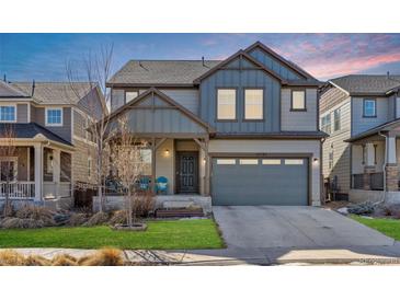 Two-story house with gray siding, landscaping, and a two-car garage at 15792 E Otero Cir, Centennial, CO 80112