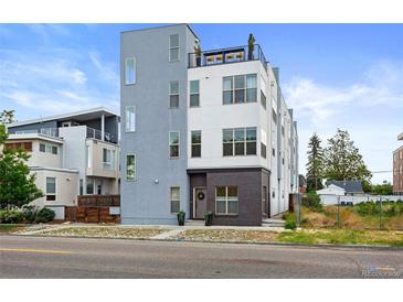 Modern townhome showcasing contemporary architectural design with clean lines and mixed material facade at 4950 Lowell Blvd, Denver, CO 80221