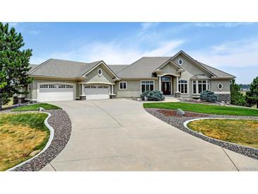 Stunning home with a three-car garage, landscaped front yard, and a long driveway at 9298 Spirit Ct, Parker, CO 80138