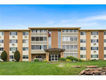 Inviting exterior of a tan and brown apartment building with manicured lawn and charming architectural details at 795 S Alton Way # 11C, Denver, CO 80247