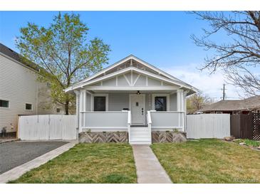 Charming bungalow-style home with inviting front porch, well-maintained lawn and landscaped planters at 3057 S Fox St, Englewood, CO 80110