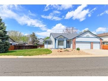 Charming single-Gathering home featuring a two-car garage and a beautifully landscaped front yard at 12935 Lake Circle Dr, Thornton, CO 80241