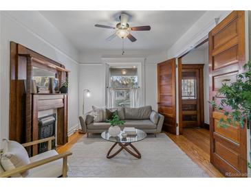 Bright living room with a decorative fireplace, hardwood floors, and natural light at 39 S Grant St, Denver, CO 80209