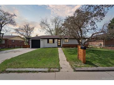 Charming single-story home with a well-manicured lawn and a freshly painted white exterior at 2840 Cottonwood Dr, Denver, CO 80221