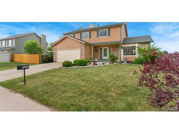 Charming two-story home with well-maintained lawn and beautiful landscaping at 2954 E 101St Ave, Thornton, CO 80229