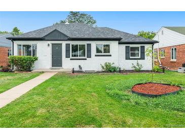 Charming single-story home with a well-maintained lawn, crisp white exterior, and black accents at 1345 Holly St, Denver, CO 80220