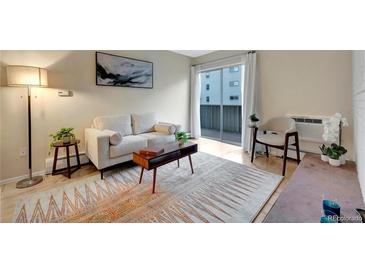 Bright living room featuring a sliding glass door to balcony and stylish decor on light wood floors at 4110 Hale Parkway Pkwy # 3J, Denver, CO 80220