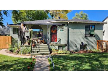 Charming bungalow with a welcoming front porch and well-maintained landscaping at 1303 Newport St, Denver, CO 80220