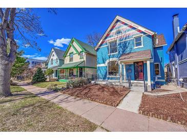 Charming street view showcasing colorful, well-maintained Victorian-style homes under a clear blue sky at 169 W Byers Pl, Denver, CO 80223